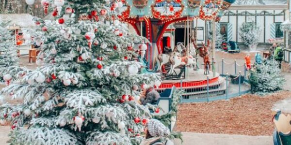 Lia admiring a giant Christmas Tree at Tivoli Gardens in Copenhagen, Denmark in the winter.