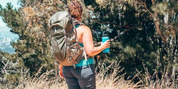 Lia in the prAna Halle pant hiking and wearing a backpack.