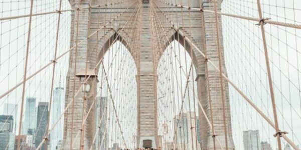 people walking across the brooklyn bridge nyc