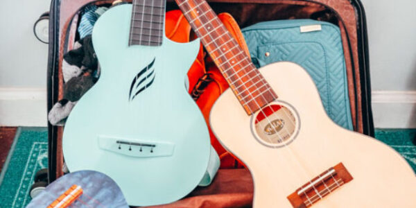 Travel ukuleles ready to take flight! Top left: Enya Nova U Ukulele, Top right: Kala Solid Spruce Travel Ukulele, and bottom: Ohana O'Nina Willow Sopranissimo Ukulele