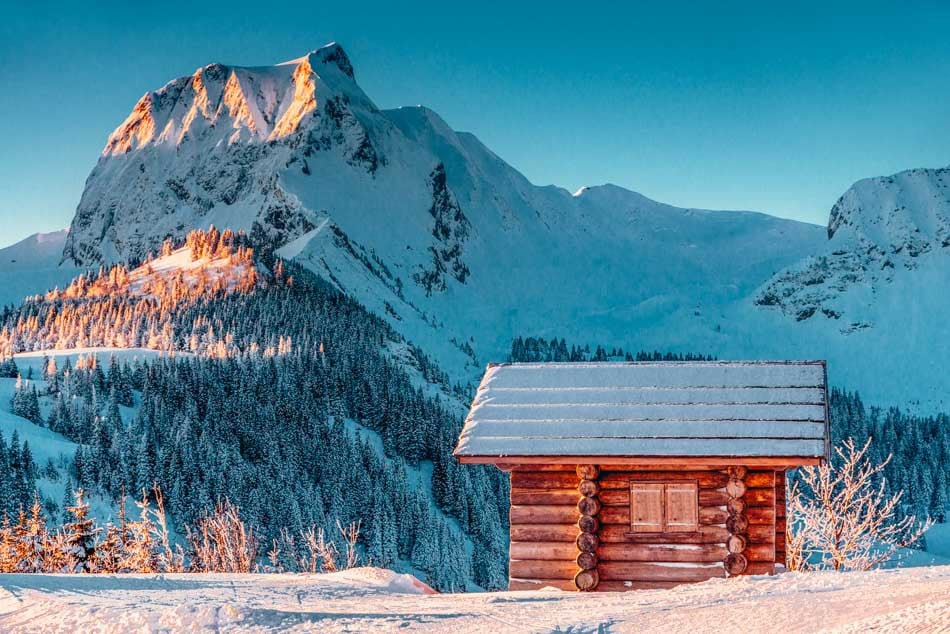 swiss chalet next to a mountain